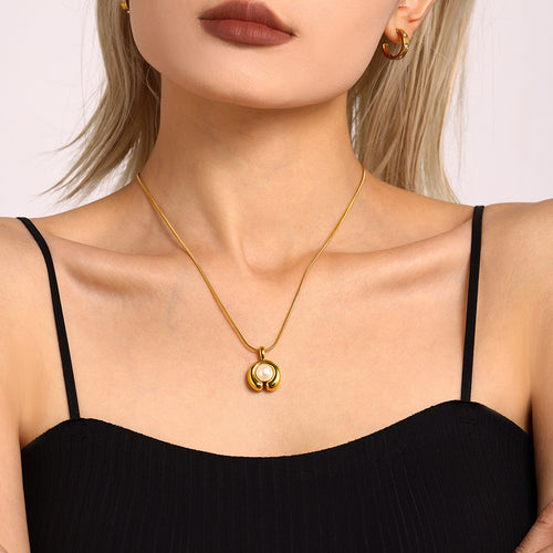 A C-shaped freshwater pearl pendant necklace made of stainless steel plated with 18K gold