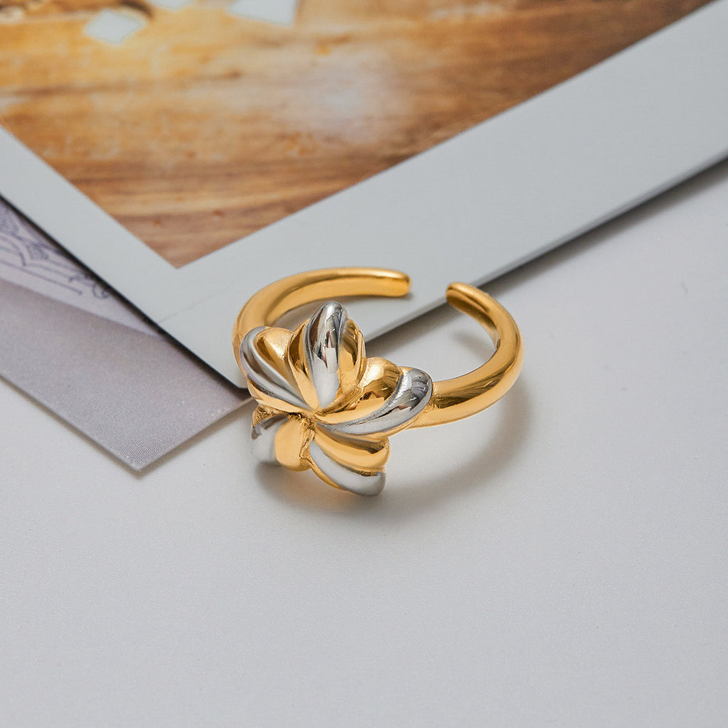 An 18K gold, stainless steel, gold and silver color-matched five-pointed star opening ring