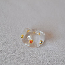 Load image into Gallery viewer, A transparent resin ring set with colored zircon