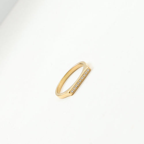 A golden stainless steel D-shaped ring set with fine diamonds
