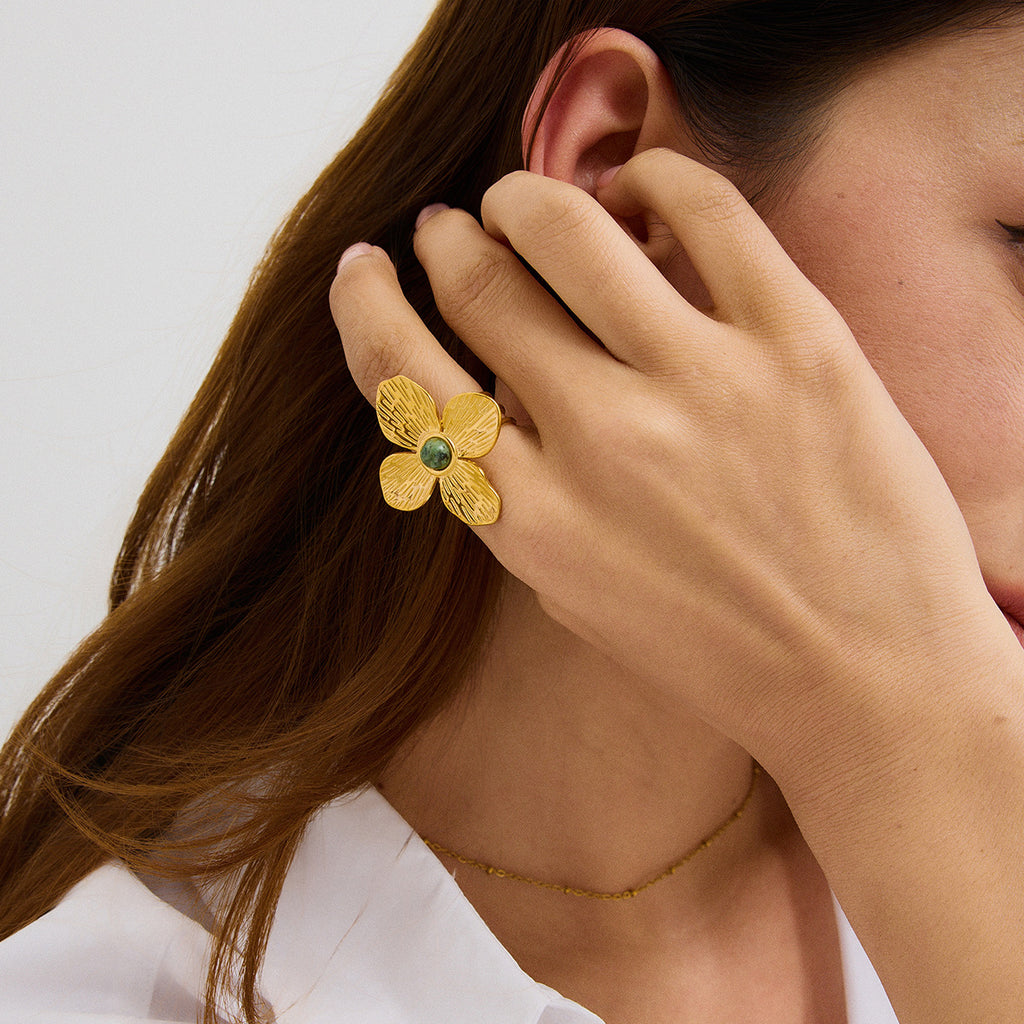 A stainless steel flower ring with a natural stone opening