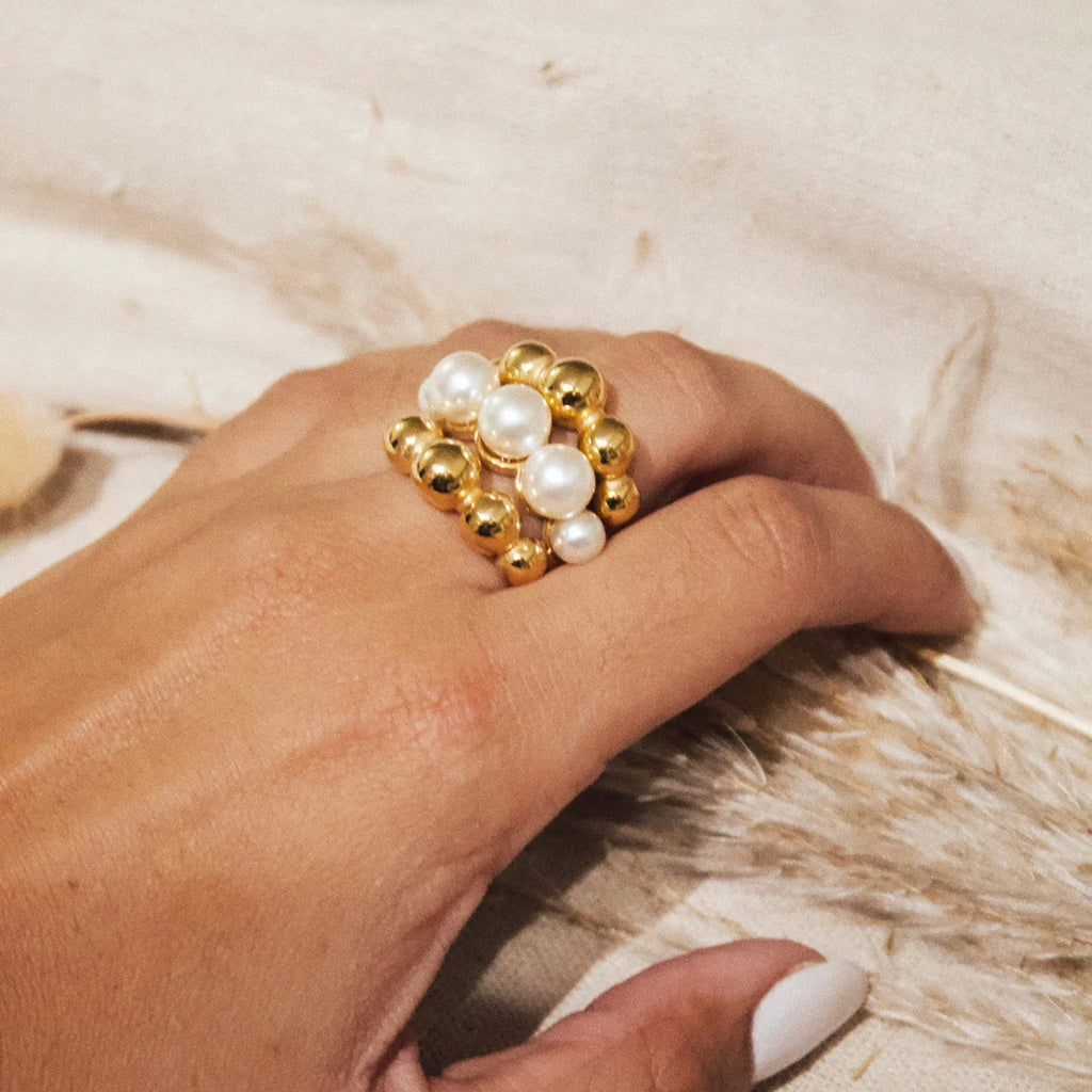 A golden stainless steel pearl round bead three-layer ring