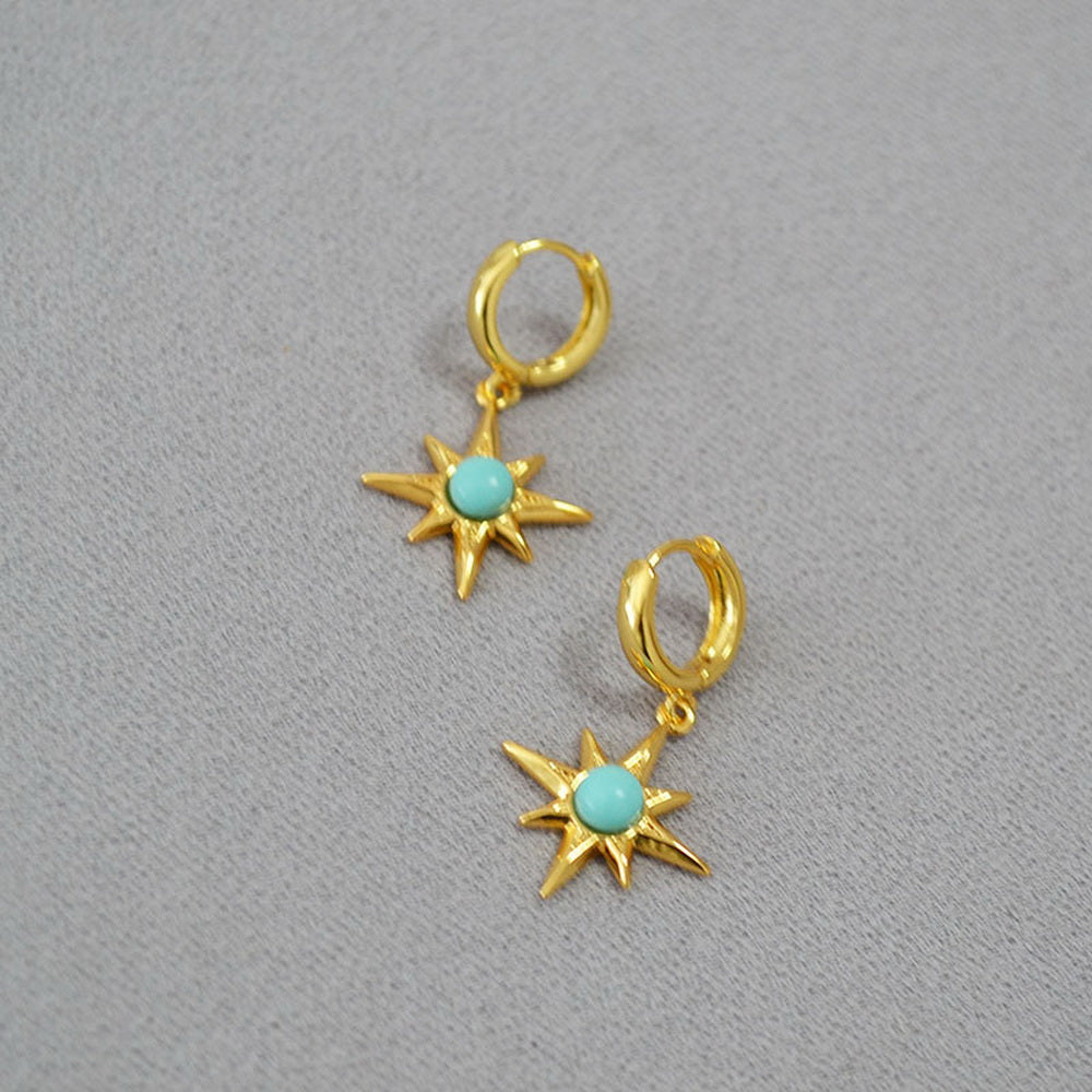 Octagonal star inlaid with turquoise and gilded brass ear buckles
