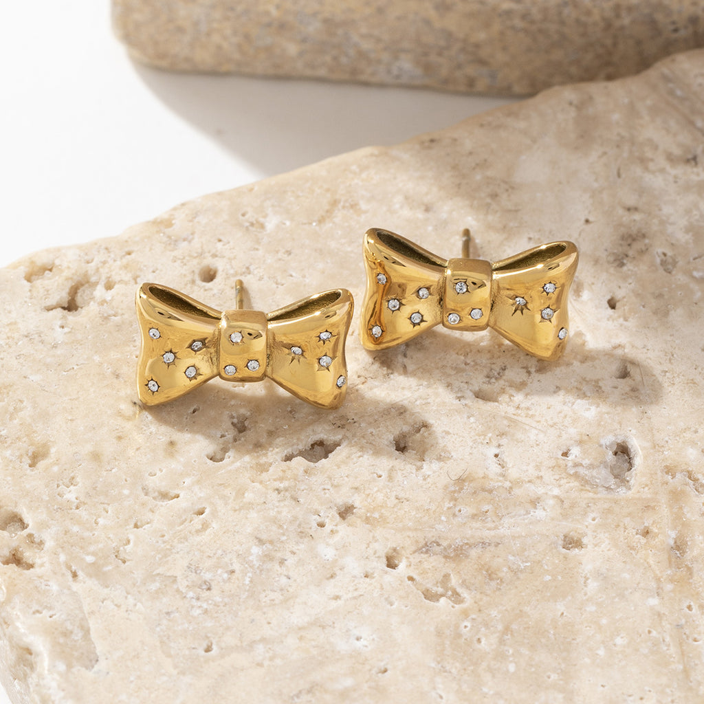 Stainless steel earrings plated with 18K gold bow and slightly set with zircon