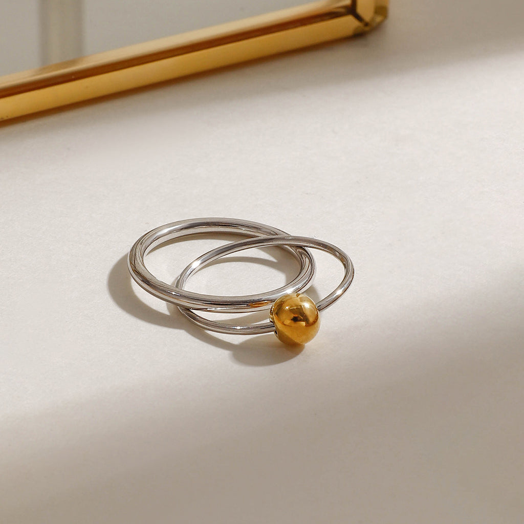 A stainless steel gold and silver color-matched double-ring ring