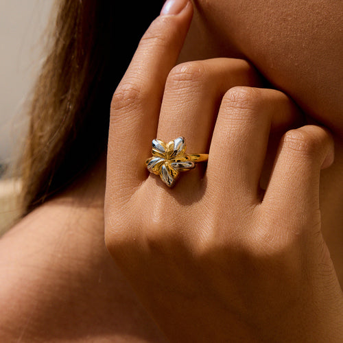 An 18K gold, stainless steel, gold and silver color-matched five-pointed star opening ring