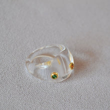 Load image into Gallery viewer, A transparent resin ring set with colored zircon