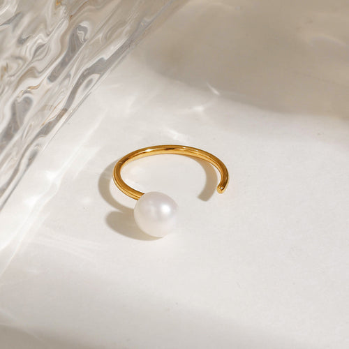 A stainless steel ring set with pearls
