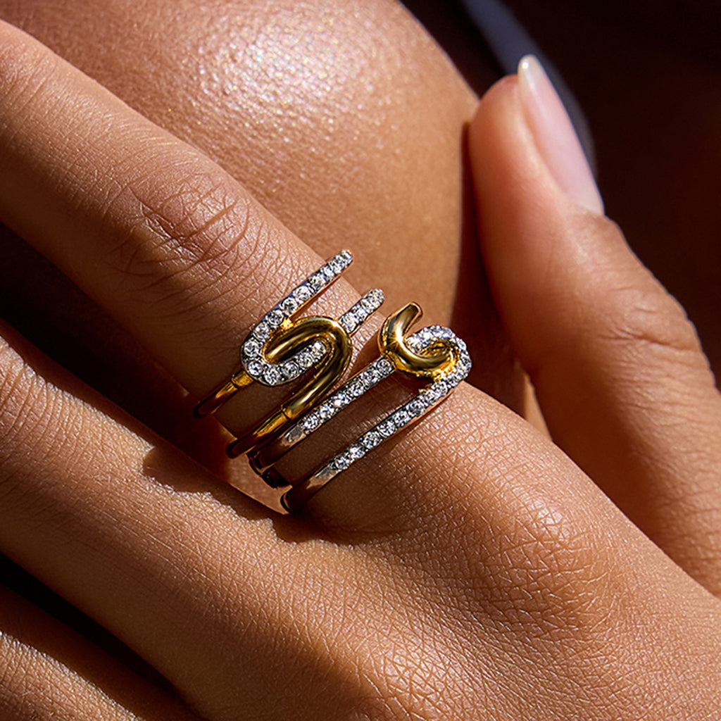 A stainless steel gold and silver color-matched rhinestone ring