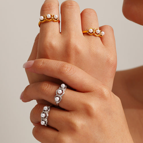 A golden stainless steel ring set with pearls