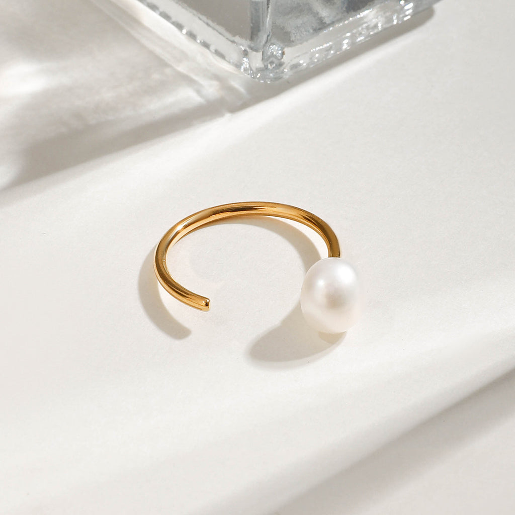 A stainless steel ring set with pearls