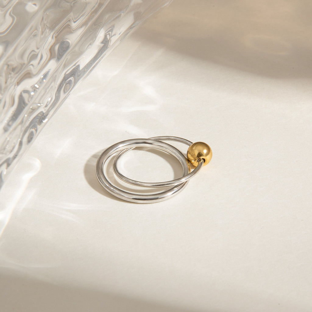 A stainless steel gold and silver color-matched double-ring ring