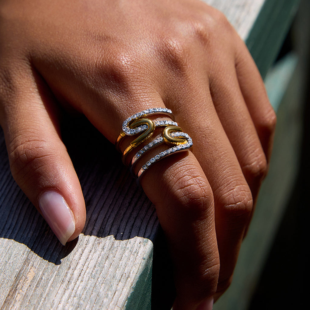 A stainless steel gold and silver color-matched rhinestone ring
