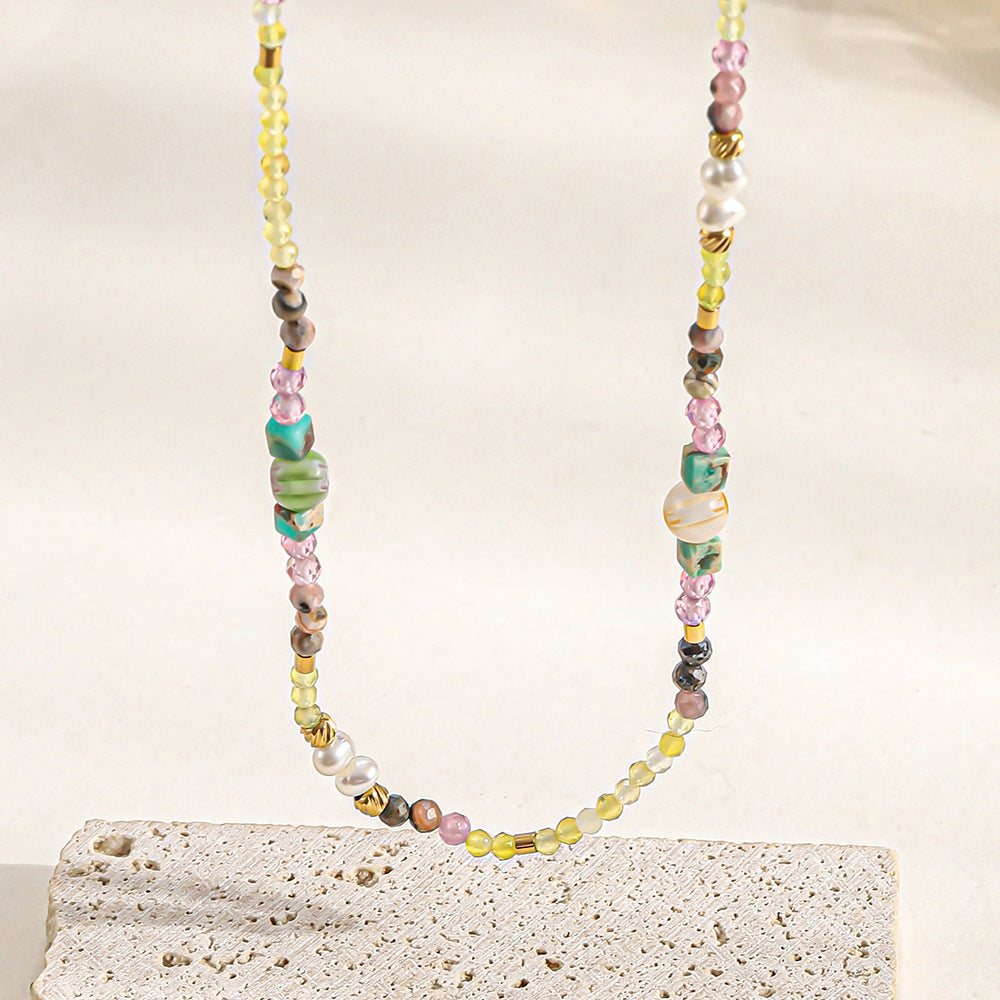 A hand-beaded necklace made of colored natural stone pearls