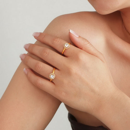 A stainless steel ring set with round white zircon