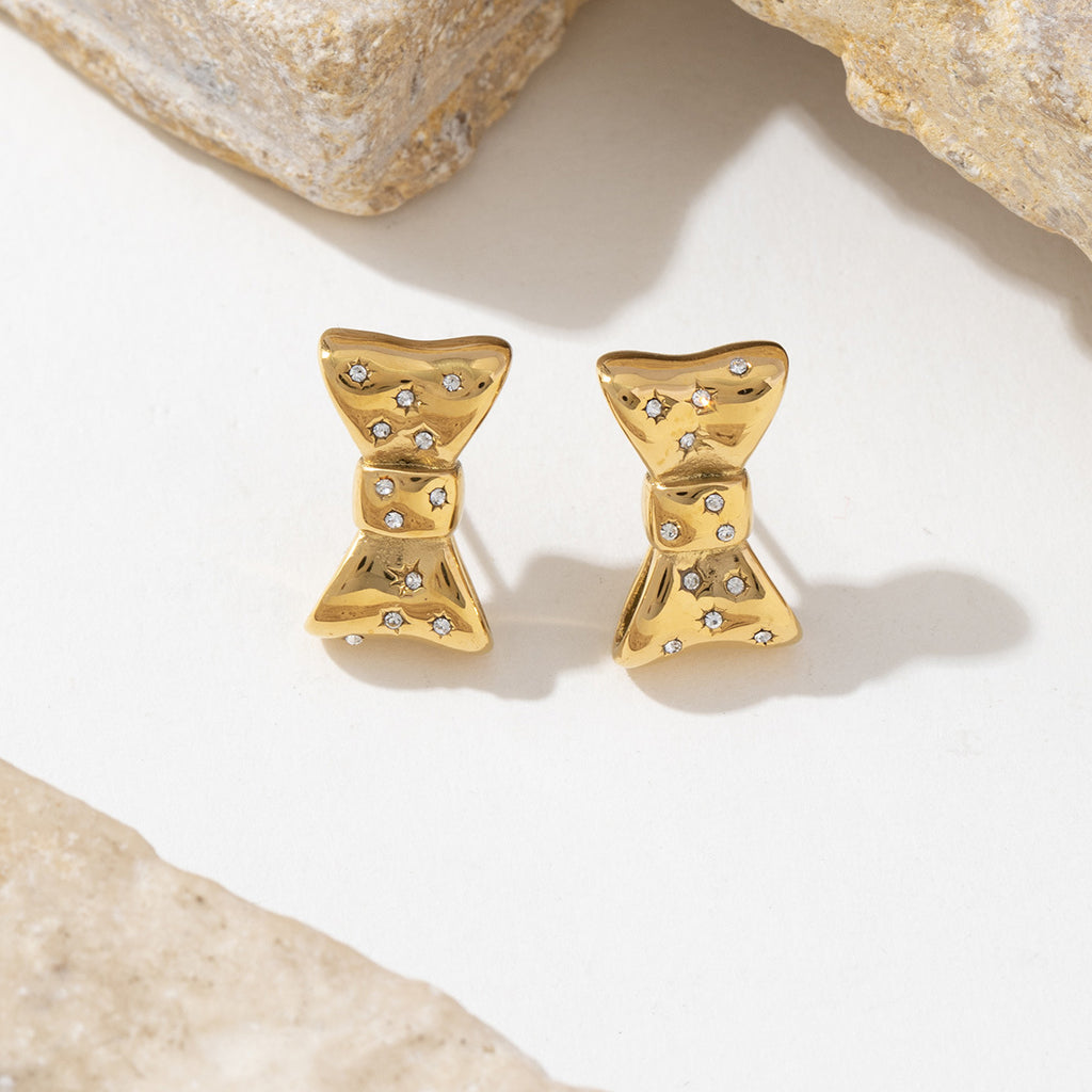 Stainless steel earrings plated with 18K gold bow and slightly set with zircon