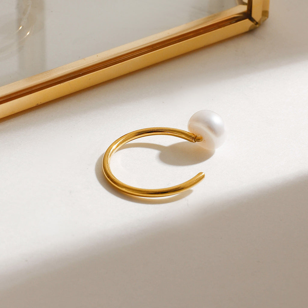 A stainless steel ring set with pearls