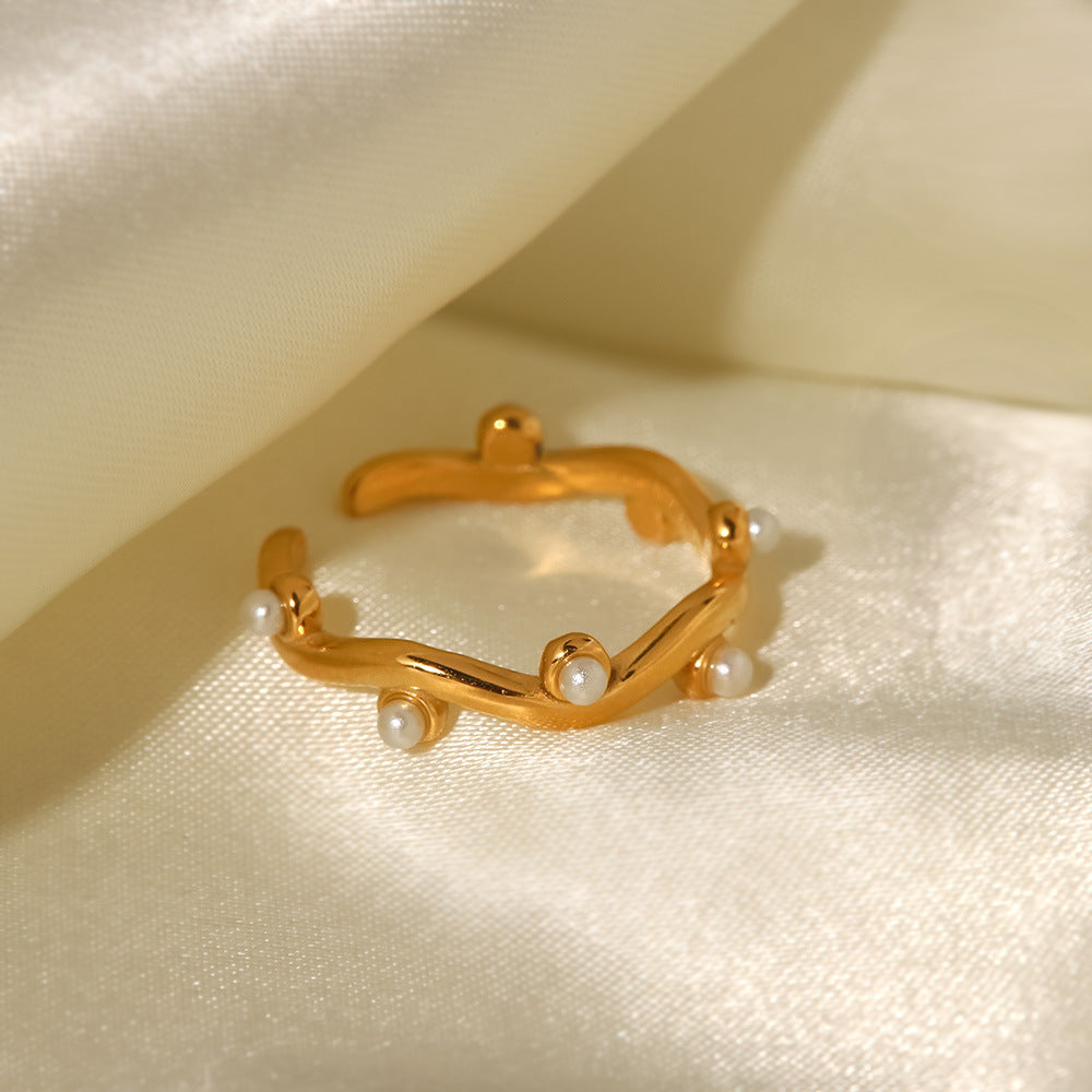 An 18K gold-plated stainless steel ring set with white pearls