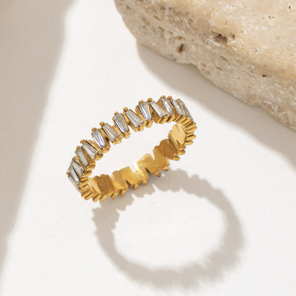 A golden stainless steel ring set with zirconium