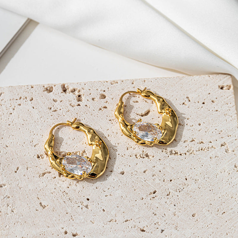 Irregularly shaped round ear loops inlaid with zirconium