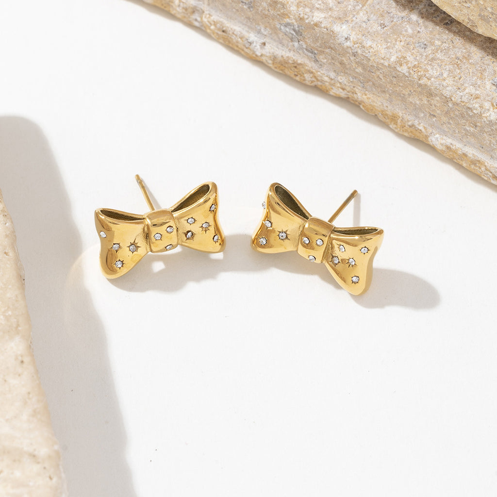 Stainless steel earrings plated with 18K gold bow and slightly set with zircon