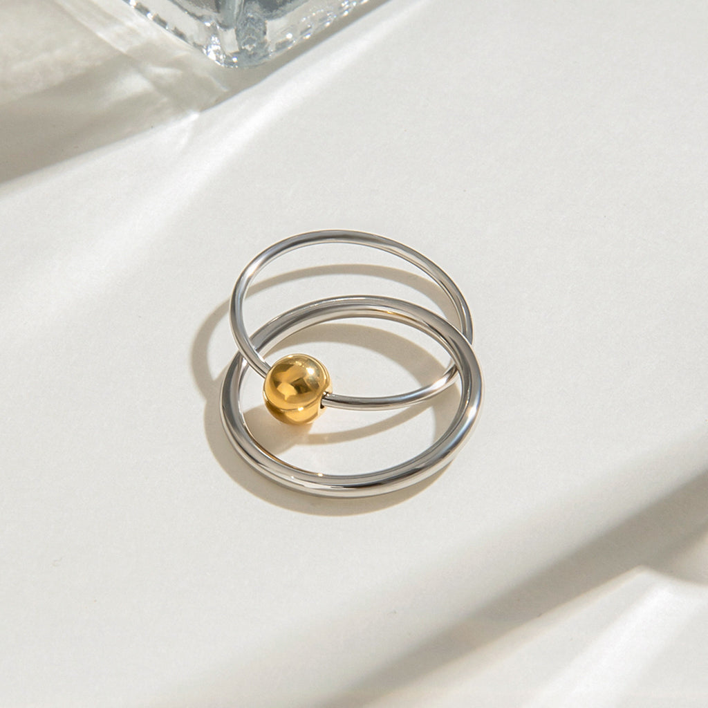 A stainless steel gold and silver color-matched double-ring ring