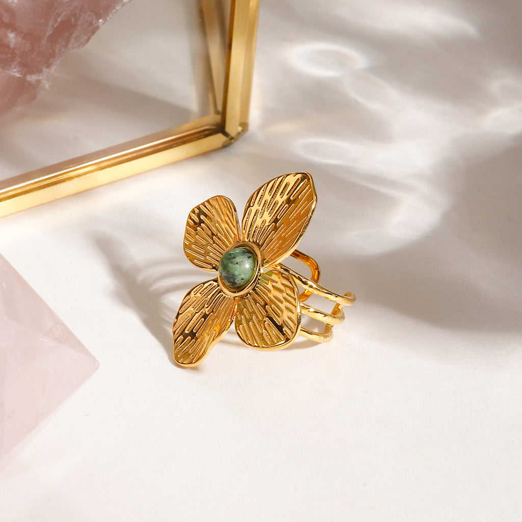 A stainless steel flower ring with a natural stone opening