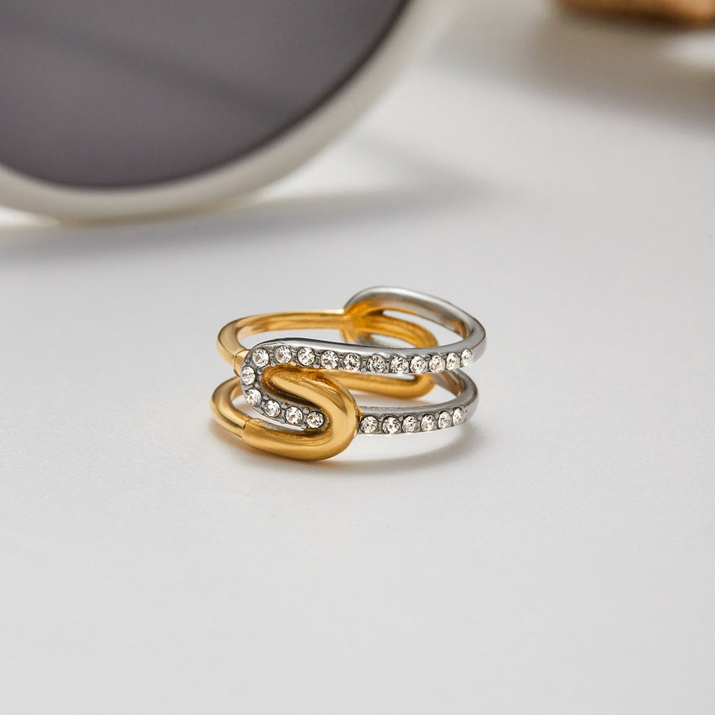 A stainless steel gold and silver color-matched rhinestone ring