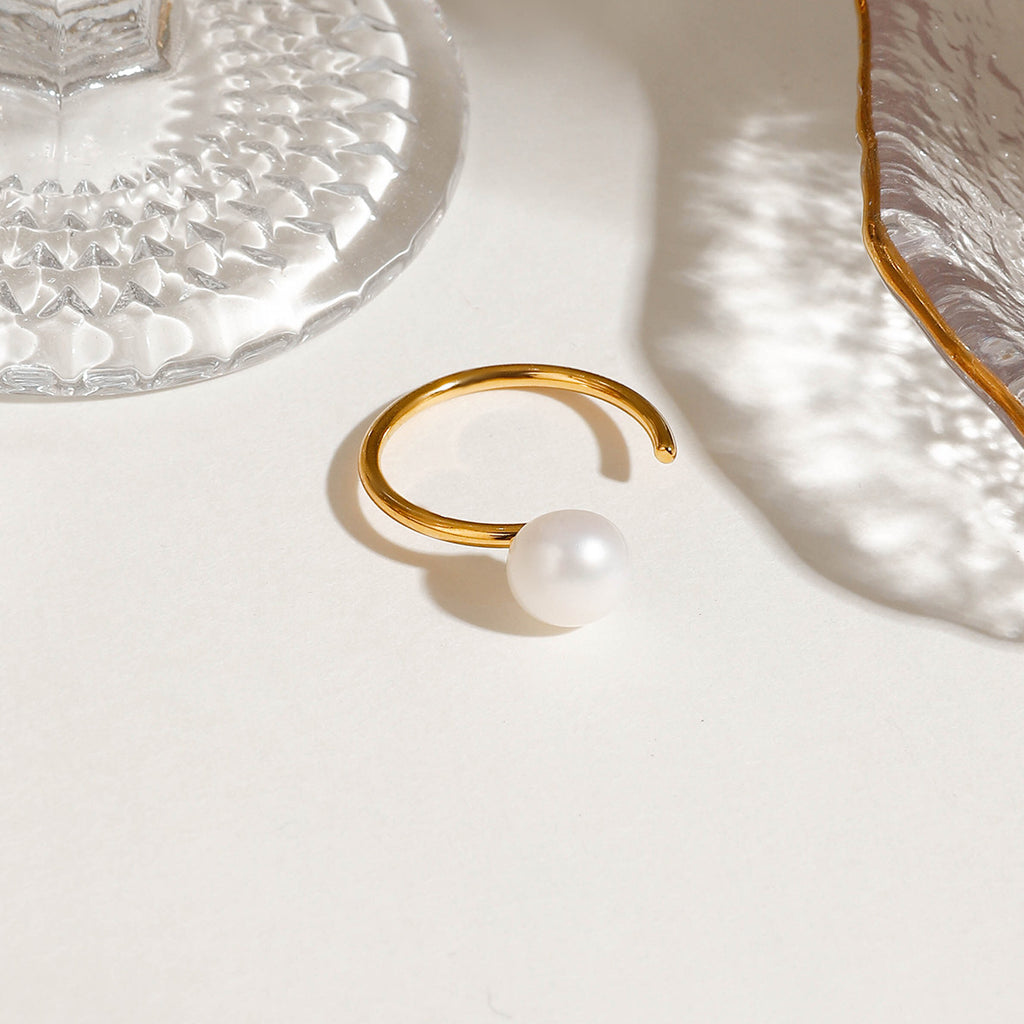 A stainless steel ring set with pearls