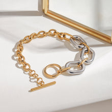 Load image into Gallery viewer, Stainless steel, gold and silver color-matched chain, oval smooth surface, hollowed-out circular OT buckle bracelet