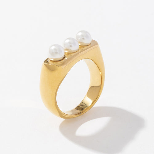 A rectangular stainless steel ring inlaid with pearls