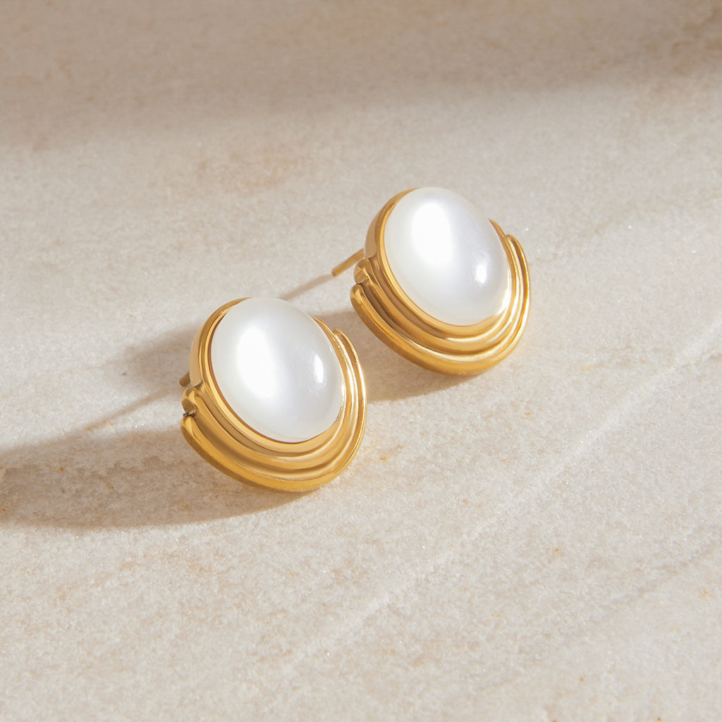 A pair of stainless steel cat-eye stone stud earrings