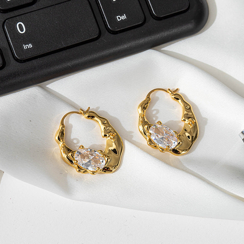 Irregularly shaped round ear loops inlaid with zirconium
