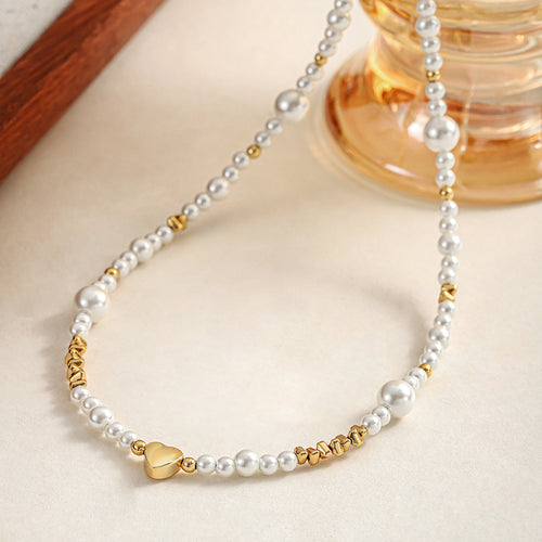 A brass gold-plated white glass bead string necklace