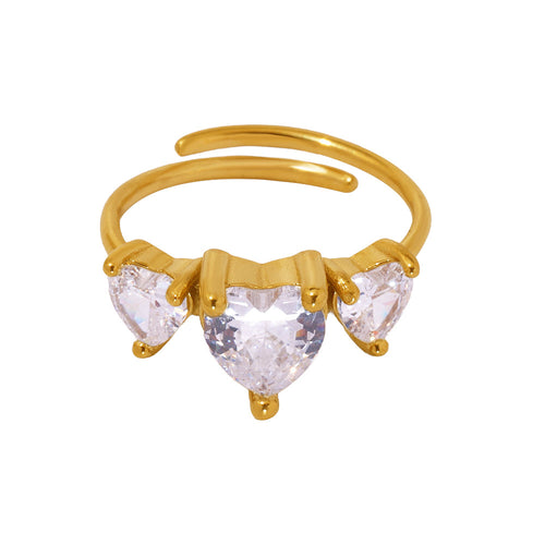 A stainless steel ring set with three heart-shaped zircon stones