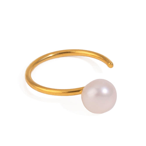 A stainless steel ring set with pearls