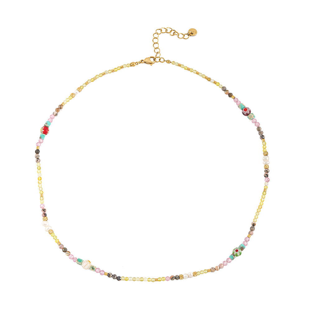 A hand-beaded necklace made of colored natural stone pearls