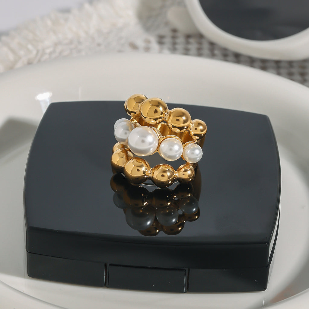 A golden stainless steel pearl round bead three-layer ring