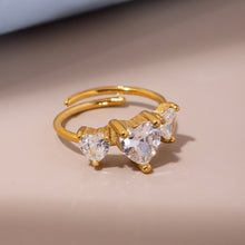 Load image into Gallery viewer, A stainless steel ring set with three heart-shaped zircon stones
