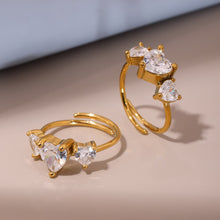 Load image into Gallery viewer, A stainless steel ring set with three heart-shaped zircon stones
