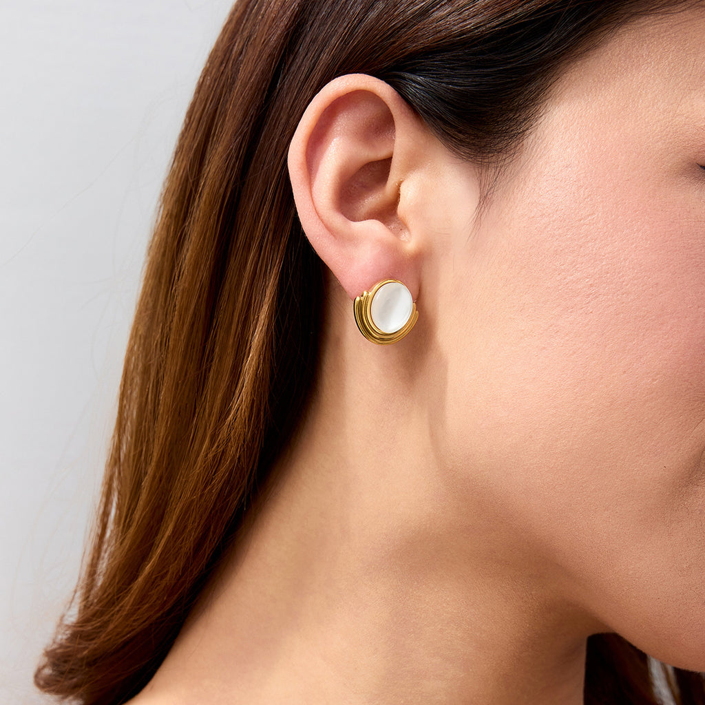 A pair of stainless steel cat-eye stone stud earrings