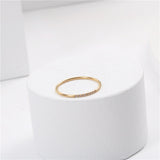A small diamond-encrusted titanium steel index finger ring plated with 18K gold