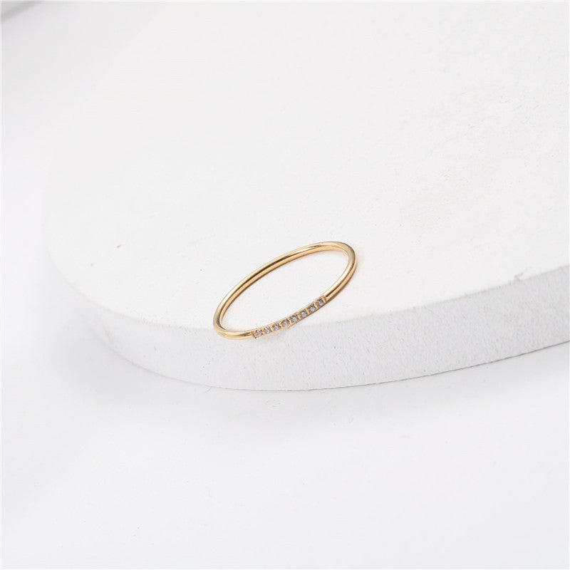 A small diamond-encrusted titanium steel index finger ring plated with 18K gold