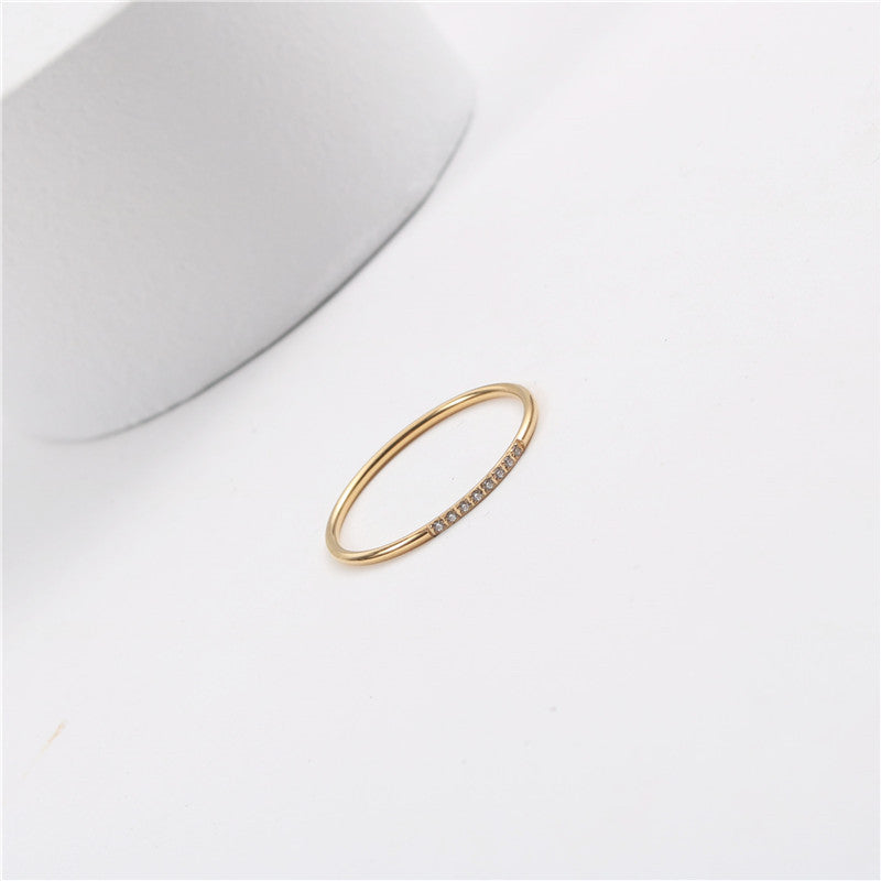 A small diamond-encrusted titanium steel index finger ring plated with 18K gold