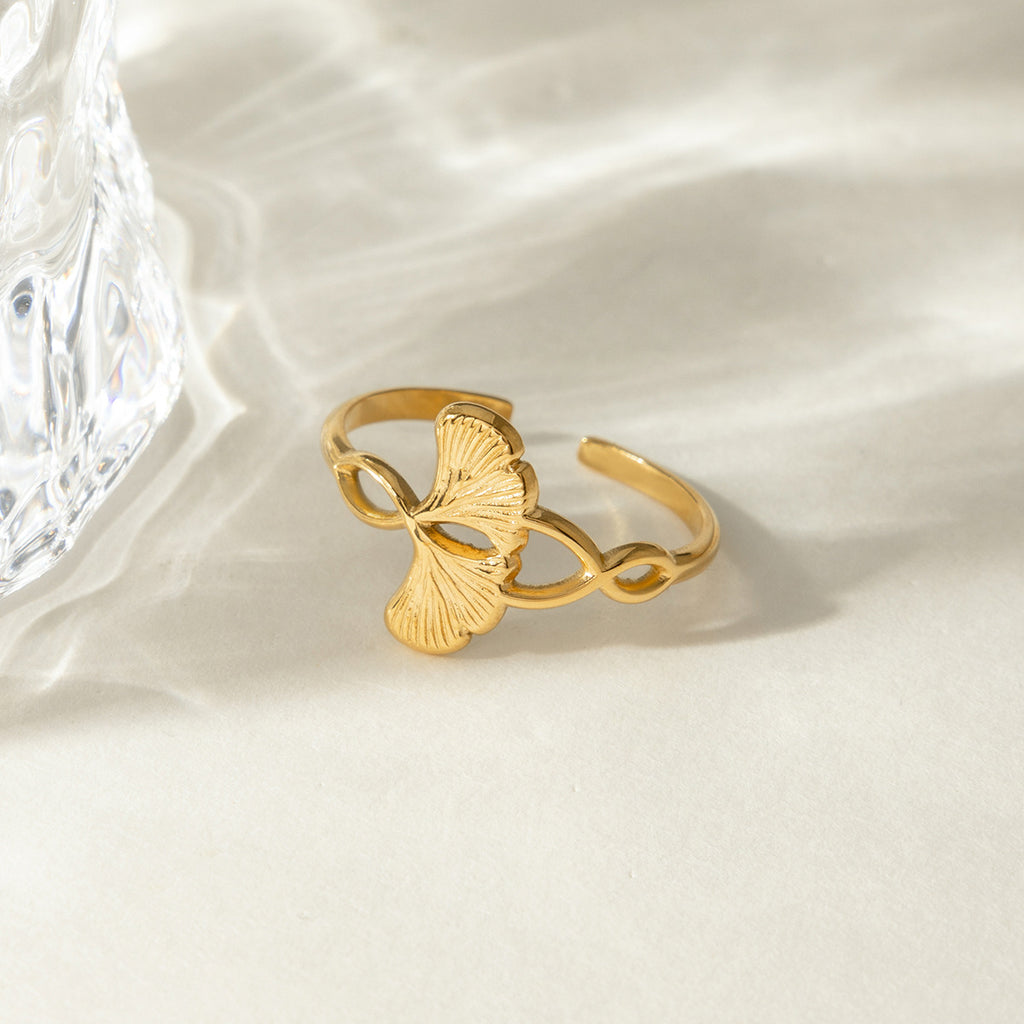 A stainless steel electroplated 18K gold line wound with ginkgo leaf adjustable opening ring