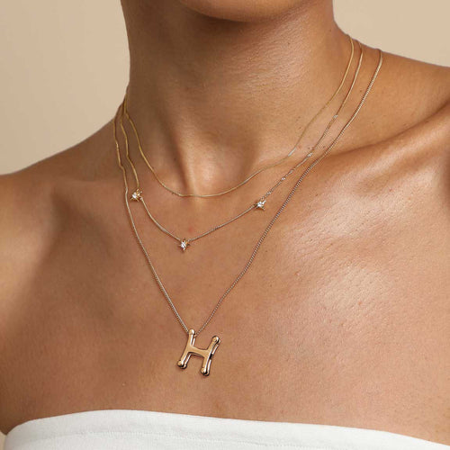 A golden stainless steel H-letter necklace