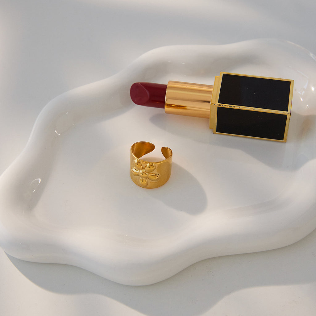 A golden stainless steel wide-face flower ring