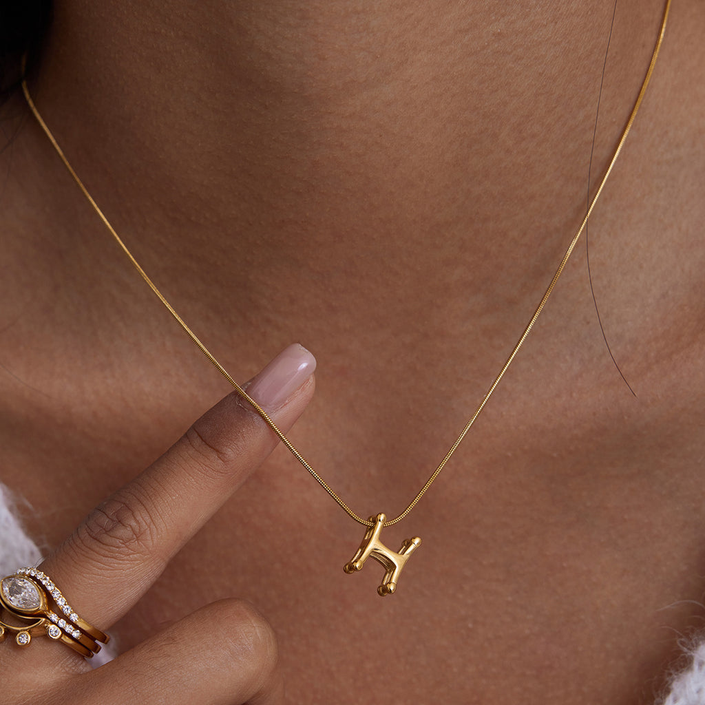A golden stainless steel H-letter necklace