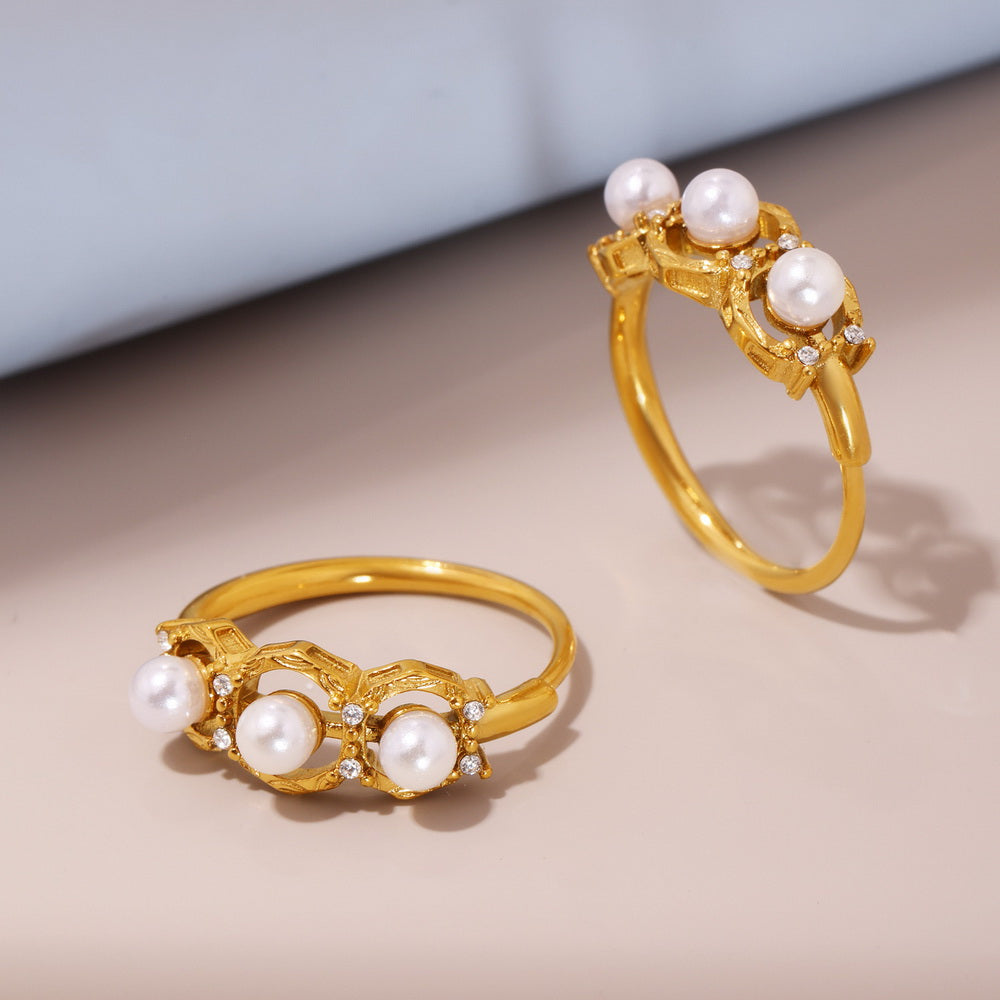 A golden stainless steel ring set with pearls