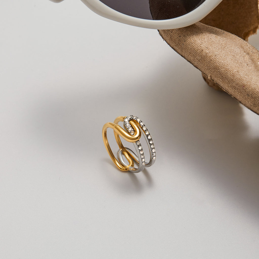 A stainless steel gold and silver color-matched rhinestone ring